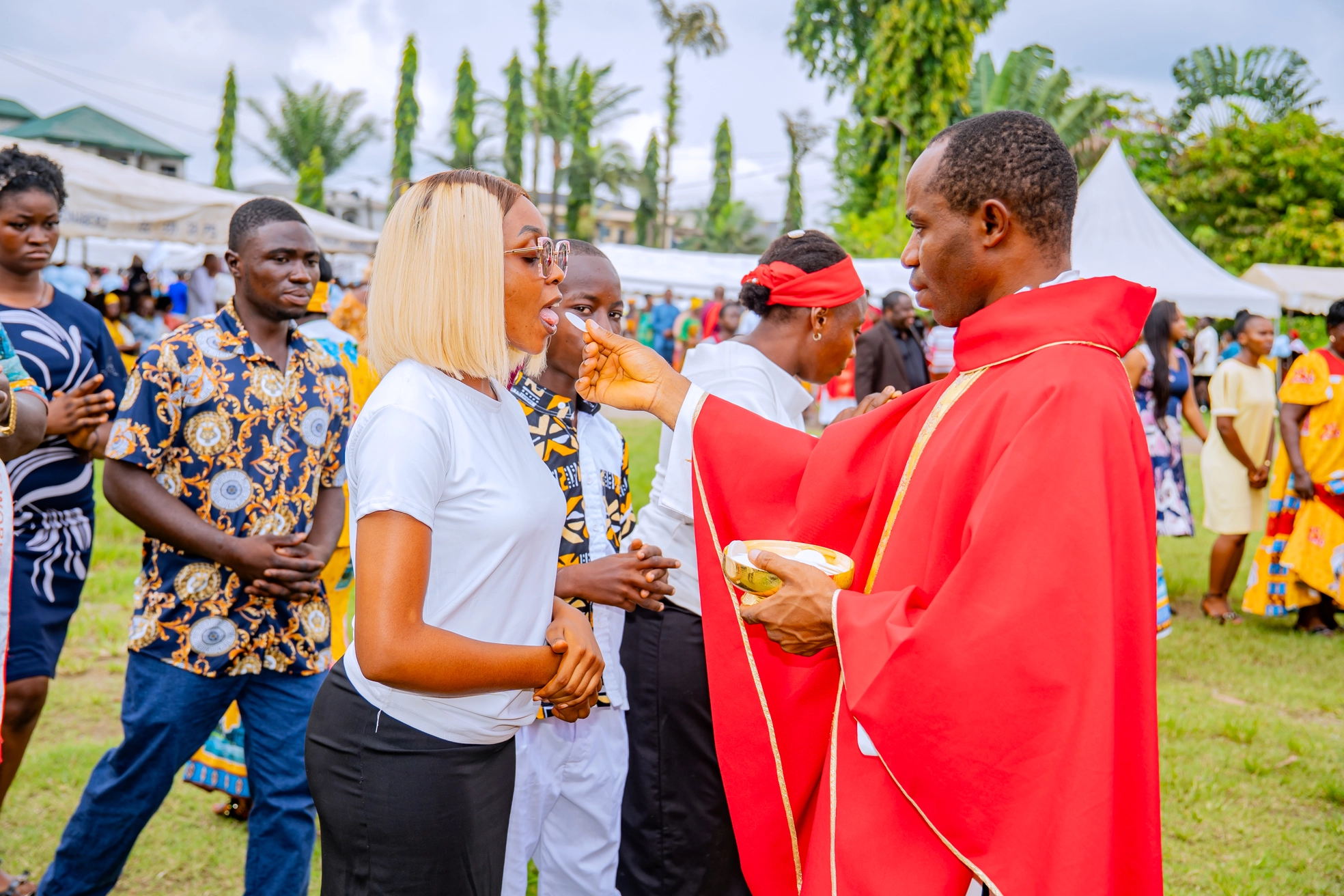 Parish Priest elevating the chalice at the consecration