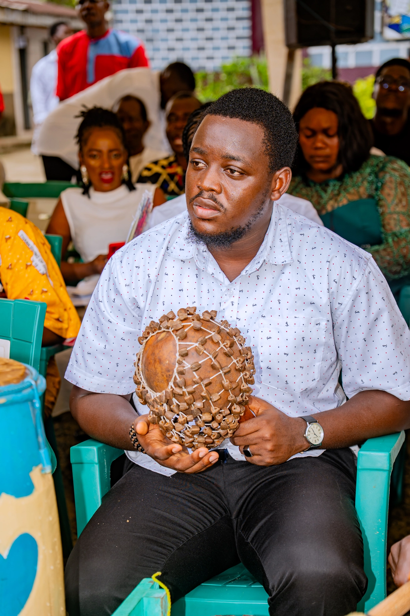 A musician holding a traditional calabash instrument