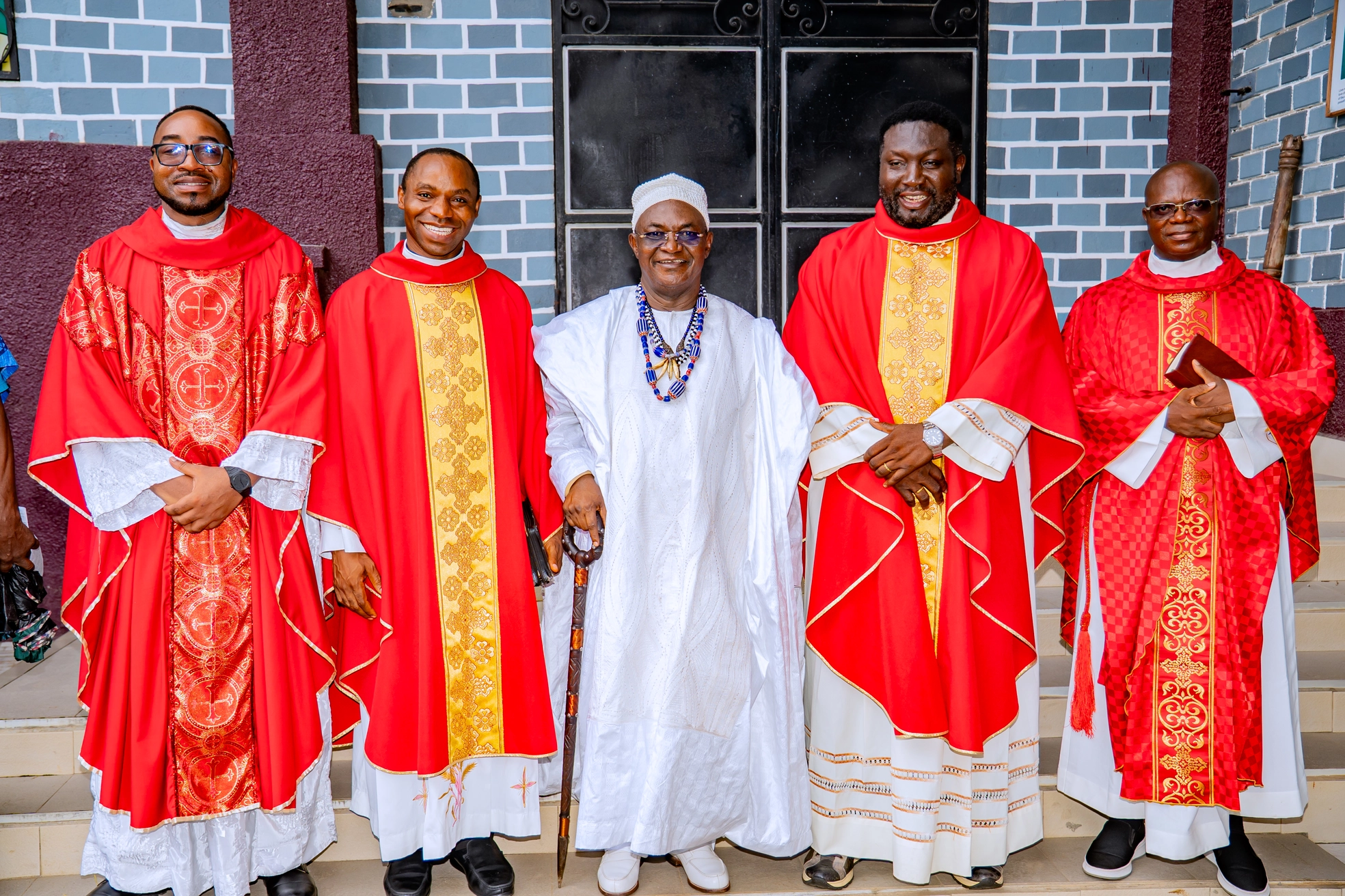 Parish Priest Fr. Agi Livinus blessing the congregation with arms raised