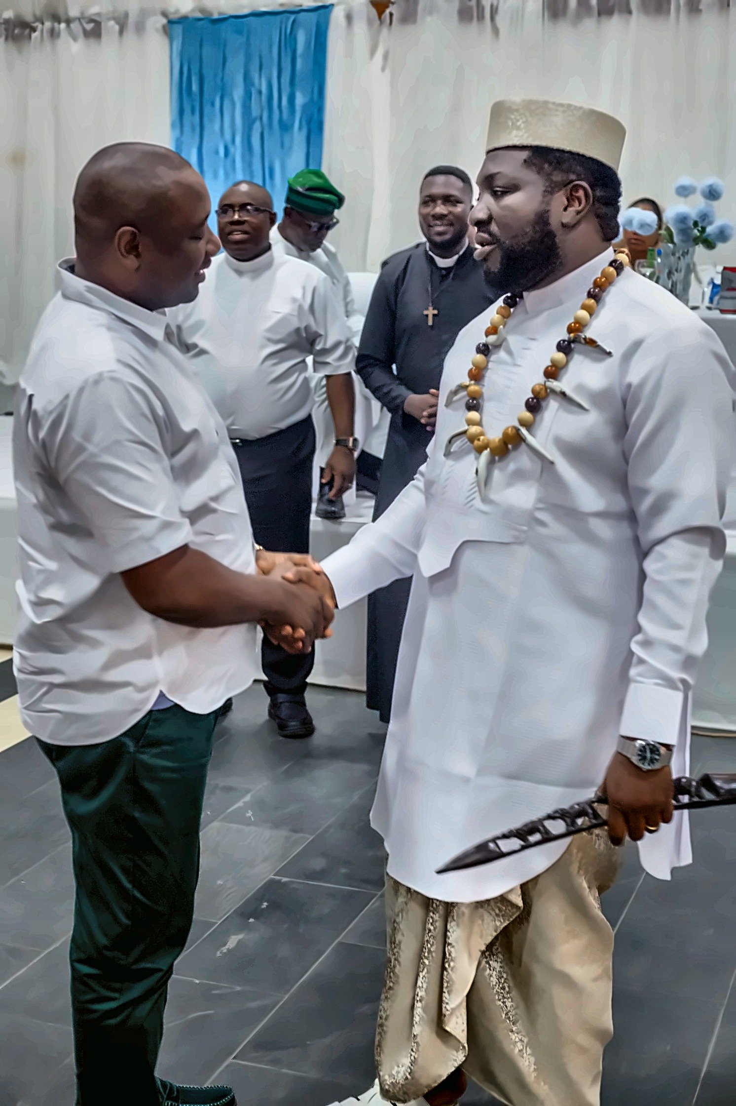 A warm handshake as well-wishers congratulate Fr. Livinus