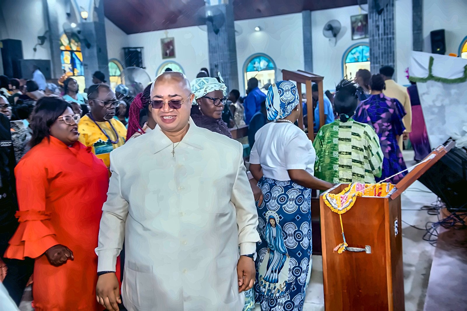 Parishioners returning to their seats after offertory, led by Prince Fombon