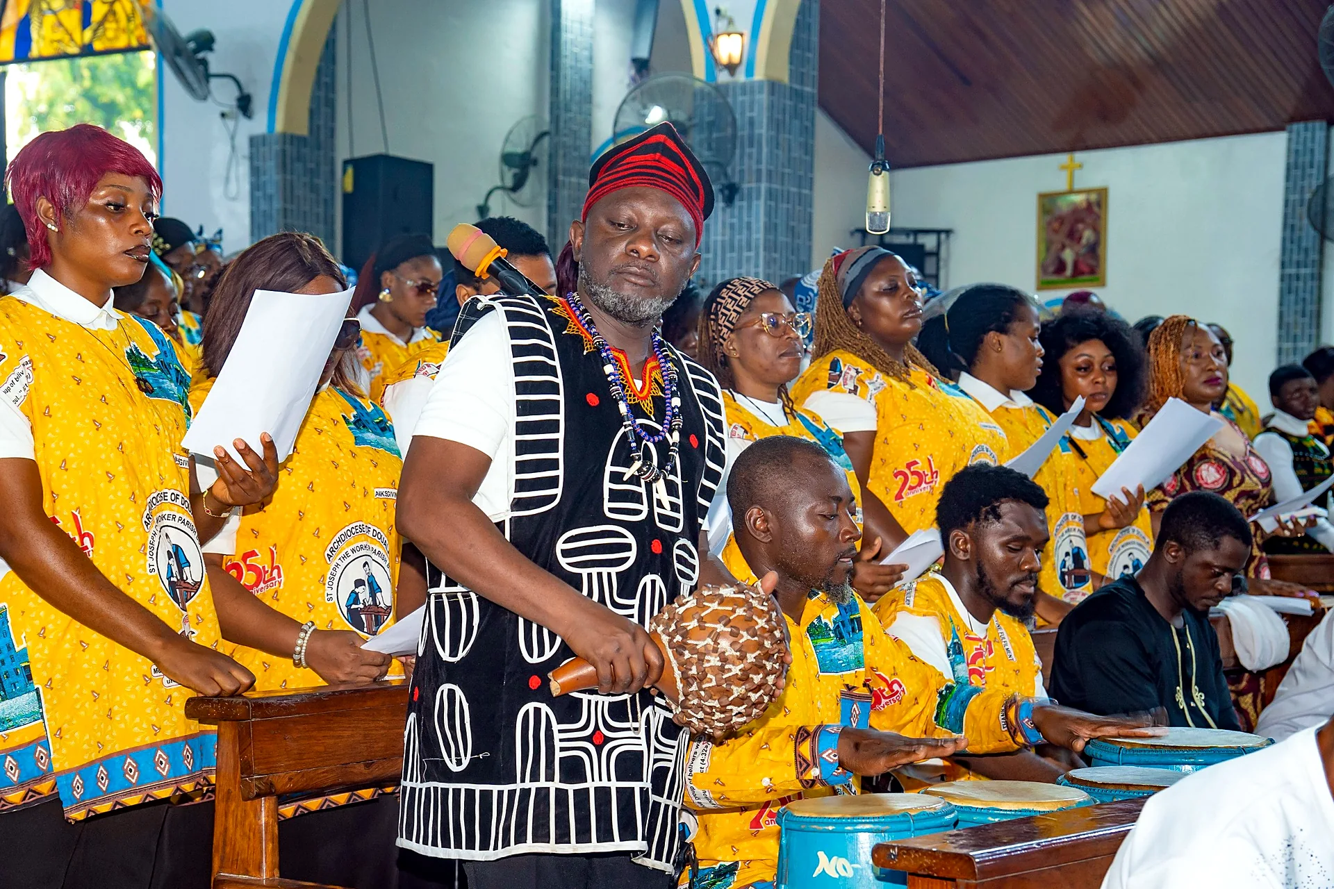 Fr. Mark Ameh Installed as Parish Priest of St. Joseph the Worker, Bonaberi The choir and drummers lead the singing