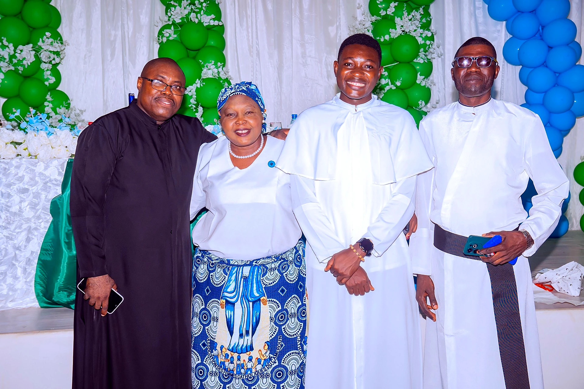 Fr. Mark Ameh Installed as Parish Priest of St. Joseph the Worker, Bonaberi The CWA President, Madam Delphine, poses with the priests