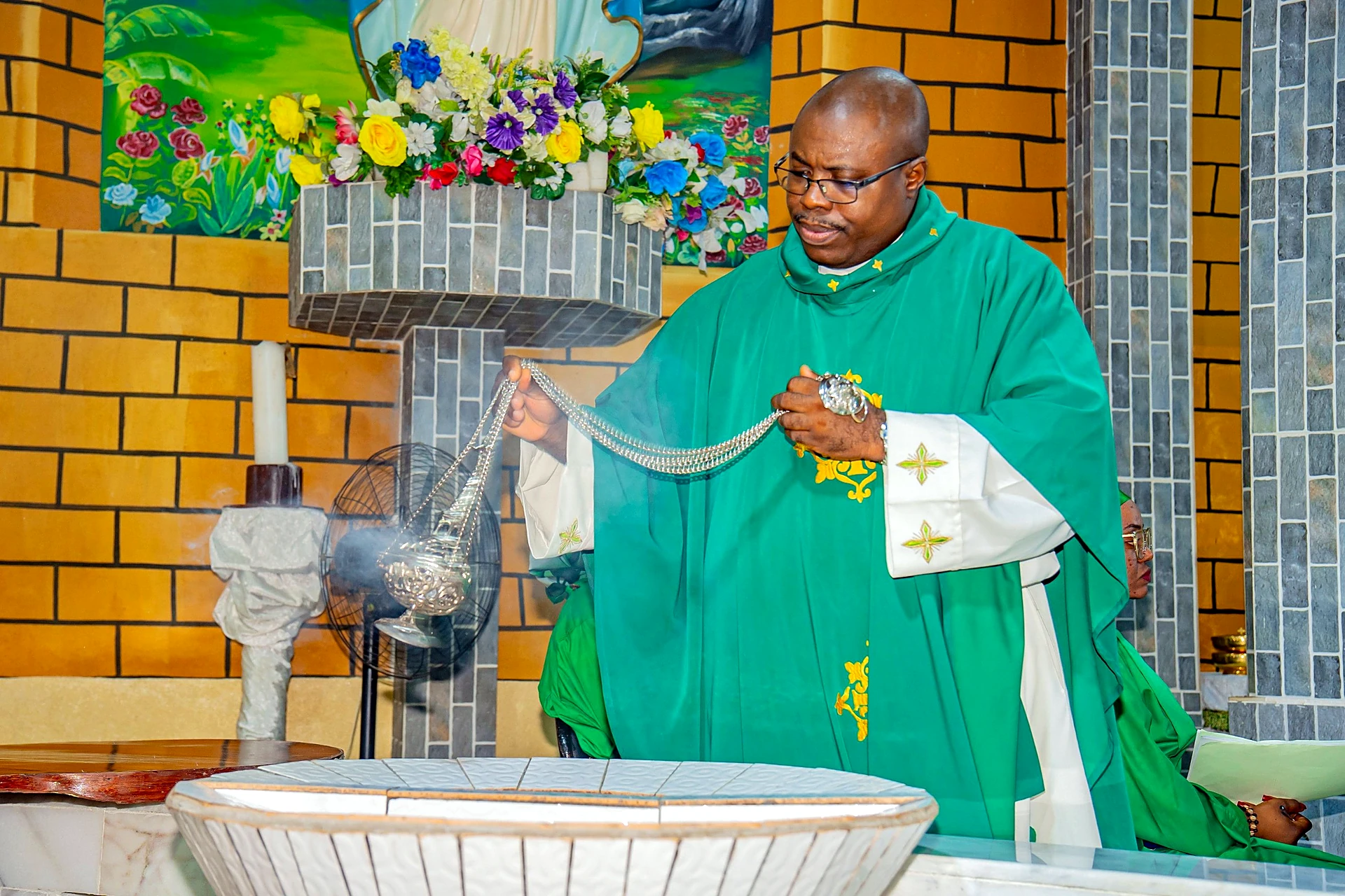 Fr. Mark Ameh Installed as Parish Priest of St. Joseph the Worker, Bonaberi Incensing the baptistery
