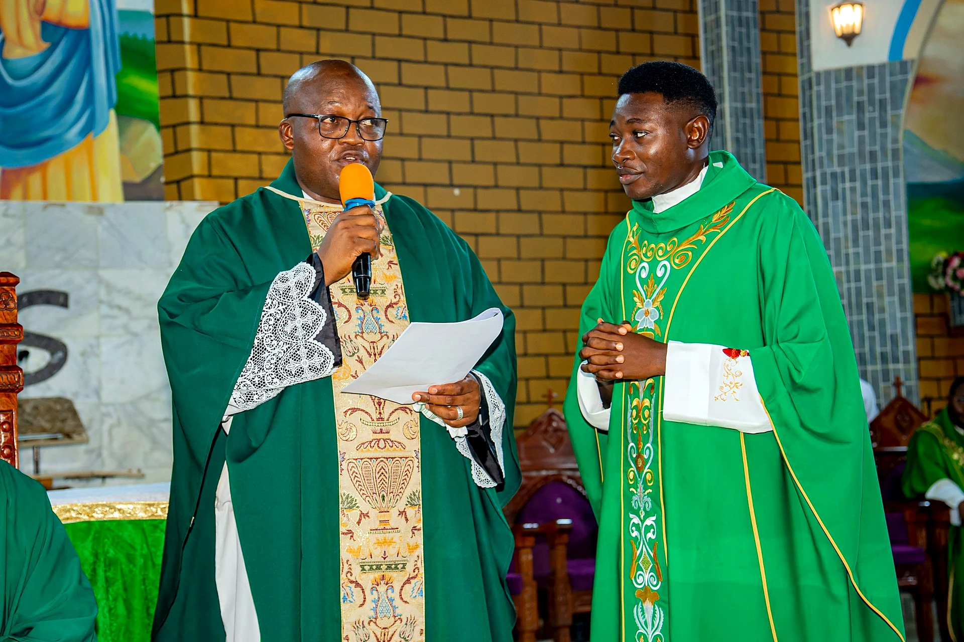 Fr. Mark Ameh Installed as Parish Priest of St. Joseph the Worker, Bonaberi Monsignor Choumbo with the assistant parish priest, Fr. Godwin Adejo